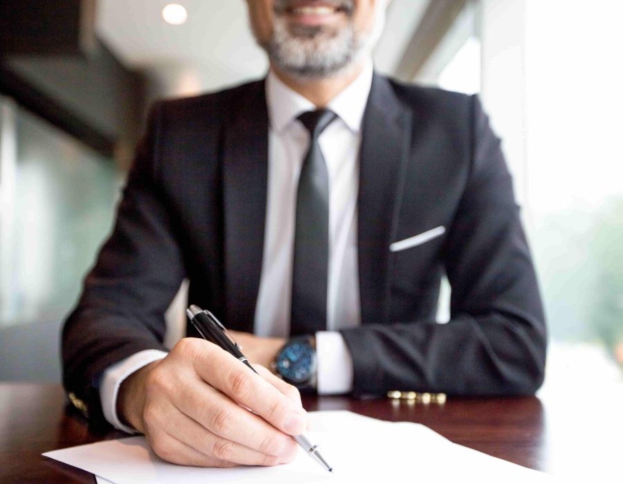 close-up-of-businessman-doing-paperwork-min